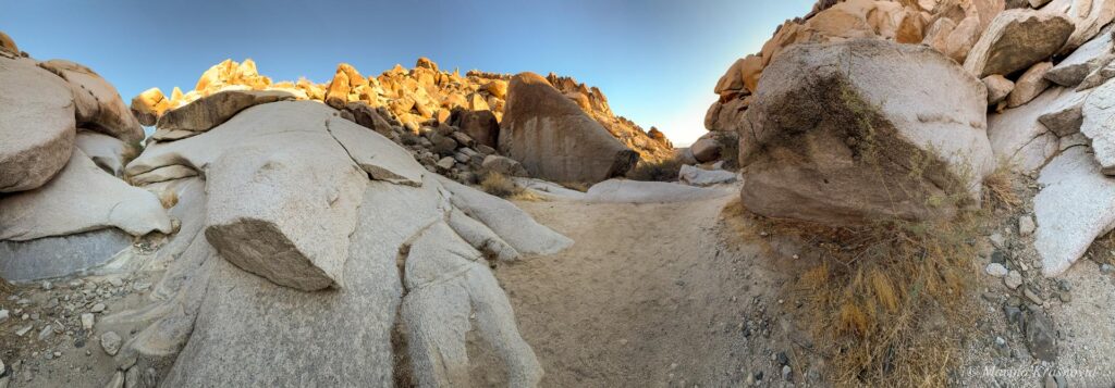 Rock formations and desert trail in Grapevine Canyon, Nevada, home to ancient petroglyphs carved into volcanic stone